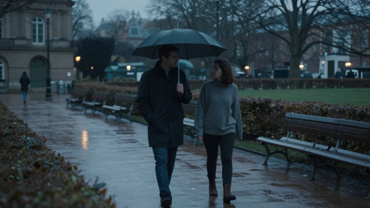 Two people walking together under an umbrella in Luxembourg Gardens during rain.